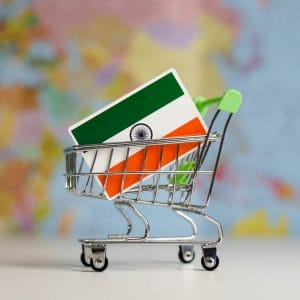 India national flag in miniature shopping trolley cart. Shopping online or shipping, duty concept.