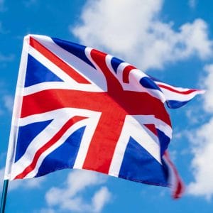 United Kingdom Flag waving on wind in blue sky