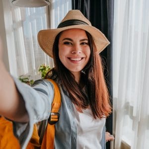 Young woman blogger making selfie using smartphone